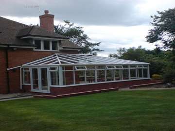 Oxton , Wirral. Design and Biuld L shaped white PvcU Conservatory.windows and doors Rehau 70 white PvcU double glazed . Roof K2 with celsius Blue 